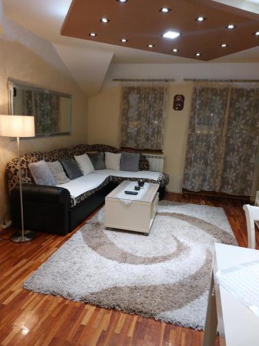 a living room with a couch and a rug at Cozy land in Šabac