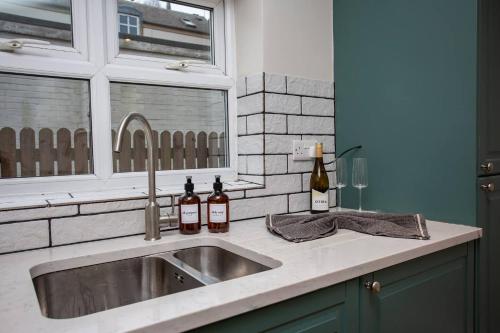 a kitchen sink with two bottles of wine on it at The Saint George in High Heaton