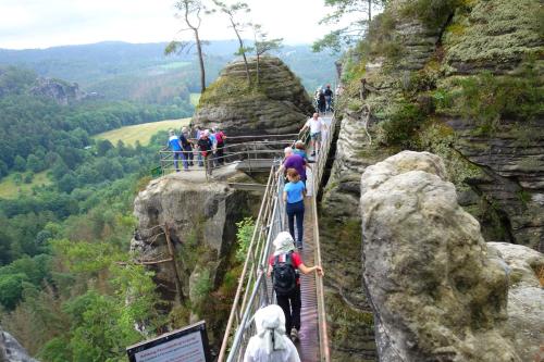 a group of people on a suspension bridge on a mountain at Pod Chlumem - útulný byt v blízkosti centra in Děčín