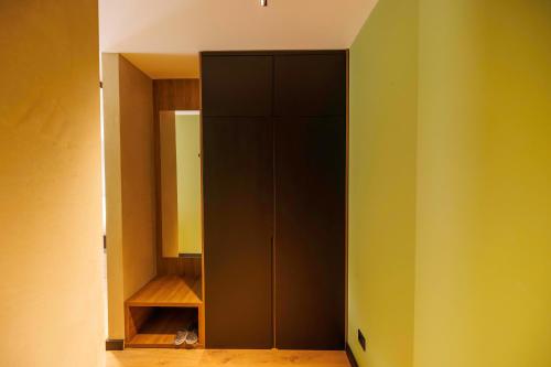 a closet with a black cabinet in a room at 1863 Boutique Hotel in Peje