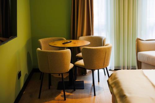 a room with a table and chairs in a room at 1863 Boutique Hotel in Peje