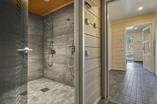 a bathroom with a shower and a walk in shower at Holy Moly by Hilla Villas in Pelkosenniemi