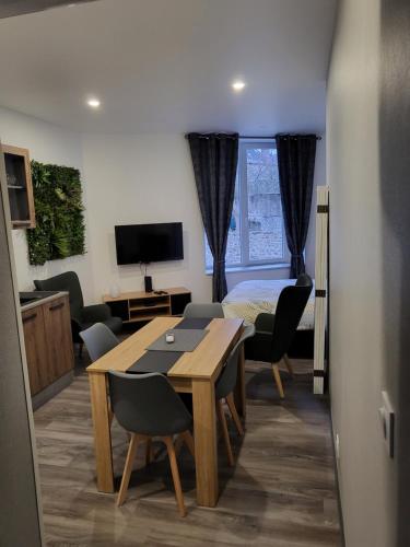 una habitación con mesa y sillas y un dormitorio en reve, en La Souterraine