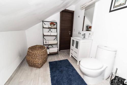 een badkamer met een wit toilet en een blauw tapijt bij CreeksideHome, 2-5min to Ski,Hiking,Lake,Cafe&Bars in Windham