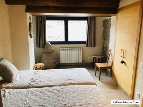 a bedroom with a large bed and a window at Cal Nen Mestre in Martinet