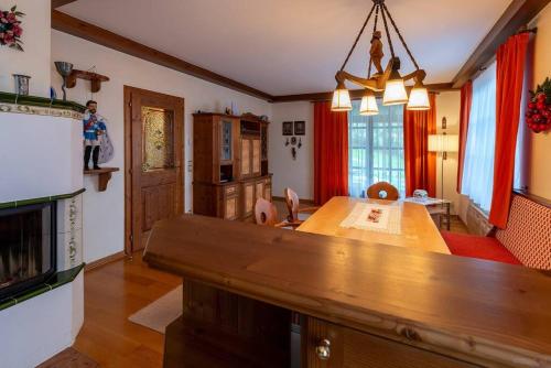 a kitchen and dining room with a wooden table in a room at Luxus Alpenparadies nahe Salzburg Sauna & Whirlpool in Adnet