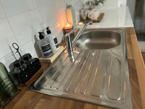 a stainless steel sink in a kitchen at Cosy studio on the Thames in London