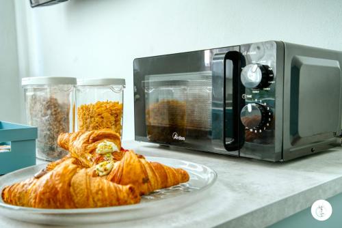 a plate of croissants sitting next to a microwave at In Curti 1913 in Parabiago