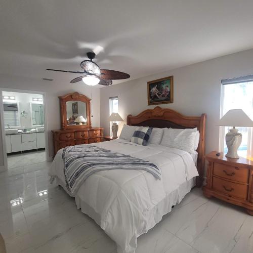 a bedroom with a bed and a ceiling fan at Sunsets by the Water in Cape Coral