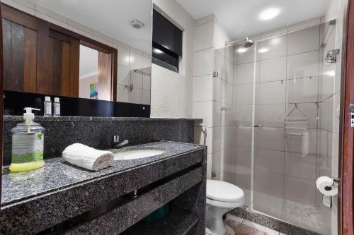 a bathroom with a sink and a toilet and a shower at Blue Marlim 2 quartos vista mar por Carpediem in Parnamirim