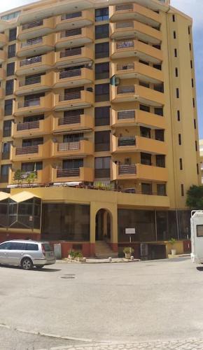 a large building with a car parked in front of it at Daloba House in Costa da Caparica