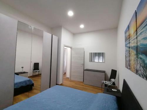 a bedroom with a bed and a dresser and a desk at Calipso casa vacanza in La Spezia