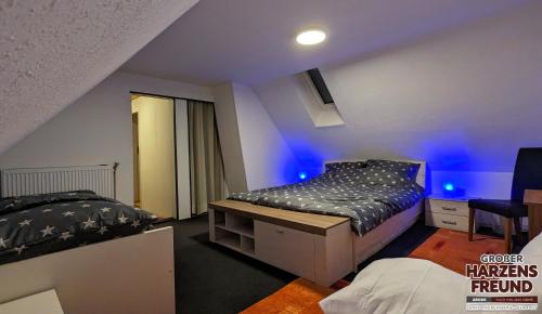 a bedroom with two beds and blue lights at Arode Ferienhaus Harzensfreund in Sankt Andreasberg