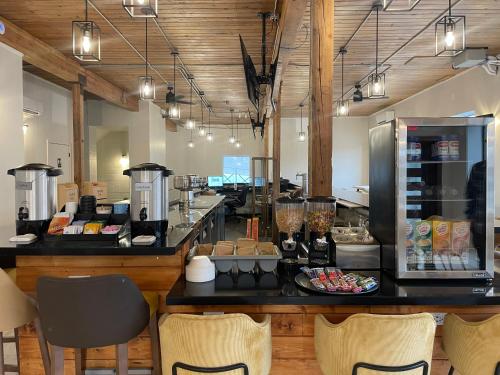 a restaurant with a counter with chairs in a room at The Hotel Pendleton, Trademark Collection by Wyndham in Pendleton