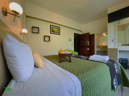 a hotel room with a bed and a table at Hotel Puente Nacional & Spa in Puente Nacional