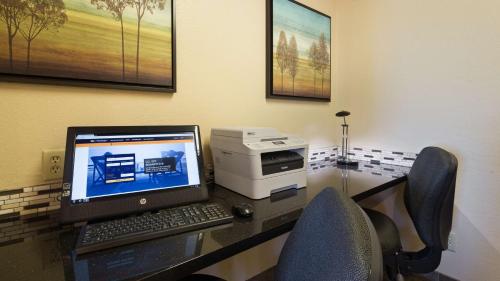 a desk with a computer and a printer on it at Best Western Plus Altoona Inn in Altoona
