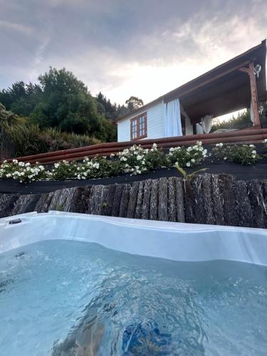 a hot tub in front of a house at The Petite Suite in Havelock