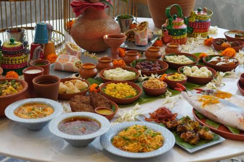a table topped with lots of different types of food at Radisson RED Chandigarh Mohali in Chandīgarh