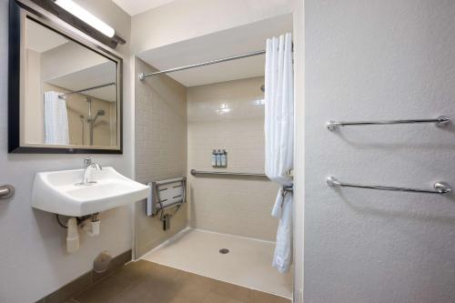 a white bathroom with a sink and a mirror at Sonesta Simply Suites Huntsville Research Park in Huntsville