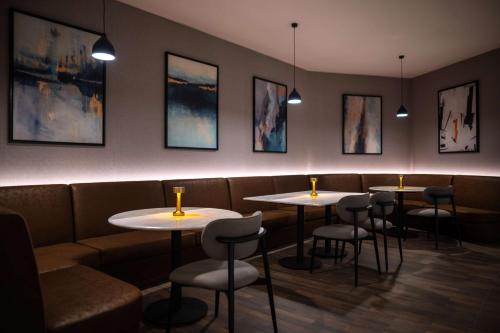 a row of tables and chairs in a restaurant at Radisson Blu Hotel, Amman Galleria Mall in Amman