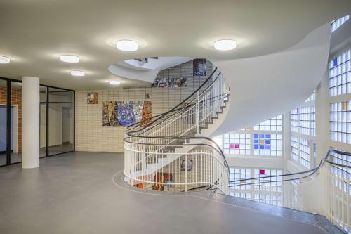 a spiralling staircase in a building with a spiral at Prize by Radisson, Dortmund City in Dortmund