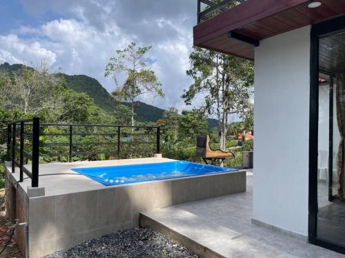 a hot tub on the patio of a house at Hermosa Cabaña cerca a Villeta in Quebradanegra