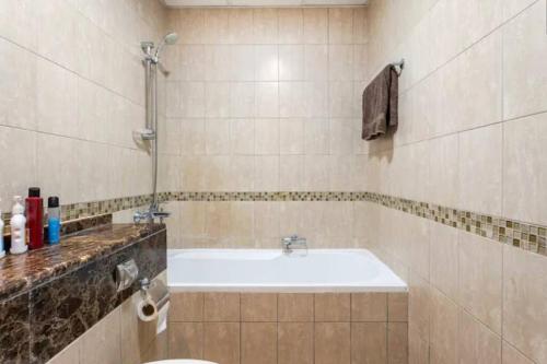 a bathroom with a sink and a bath tub at 1Bedroom Luxury Apartment By Mamzar Beach in Dubai