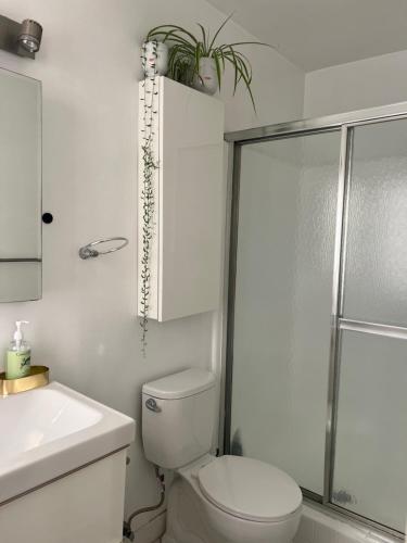 a white bathroom with a toilet and a sink at Laurel house weho historic district in Los Angeles