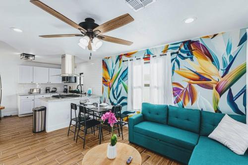 a living room with a blue couch and a kitchen at Phoenix Retreat - 2 Bedroom Home with King-Size Bed - 3 Smart TVs - 10 min from Airp - Unit A in Phoenix