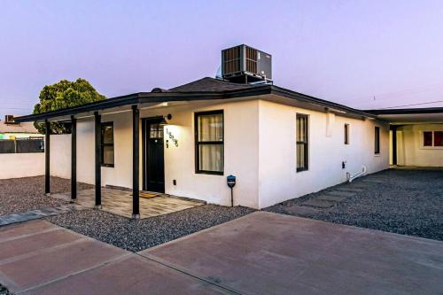 una casa blanca con una ventana encima en Phoenix Retreat - 2 Bedroom Home with King-Size Bed - 3 Smart TVs - 10 min from Airp - Unit A, en Phoenix