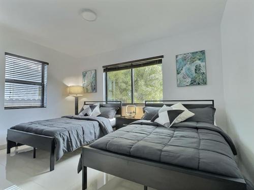1 dormitorio con 2 camas y ventana en Jacuzzi•Glamping•Gym•Parking•BBQ•Soft Beds•Secure en Miami