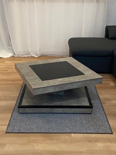 a coffee table on a rug in a living room at HM - HouseMirage in Paço de Arcos