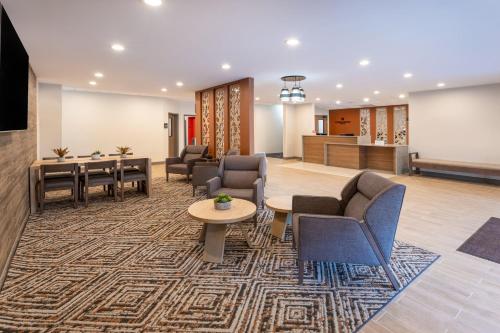 a lobby with chairs and tables and a waiting room at Candlewood Suites - Atlanta - Kennesaw by IHG in Kennesaw