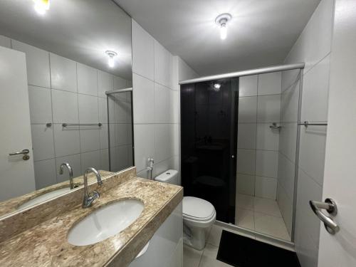 a bathroom with a sink and a toilet at Apartamento GolfVille Residence in Aquiraz