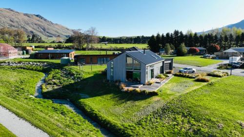 a tiny house on a lawn with a stream at Stunning, Alpine House in Kingston
