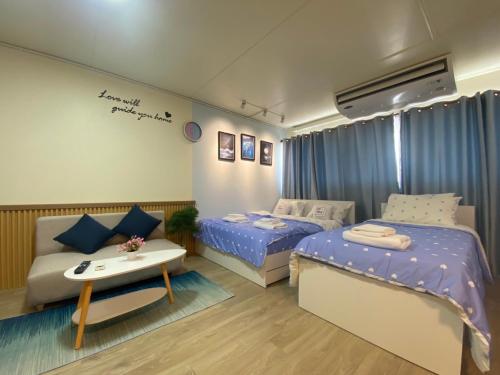 Kleines Zimmer mit 2 Betten und einem Tisch in der Unterkunft PTJ Style Condotel คอนโดเมืองทอง P1 in Ban Song Hong