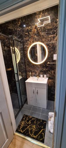 a bathroom with a sink and a mirror at luxury & comfy city break studio in London