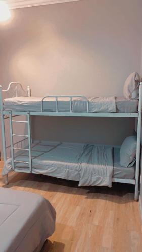 two bunk beds in a room with a wooden floor at درة العروس الحالمة in Durat  Alarous
