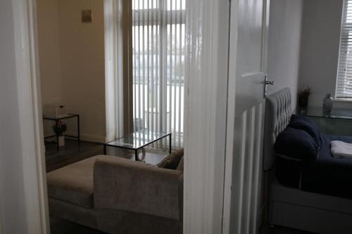 a living room with a couch and a window at 2 bedroom apartment with balcony near Tottenham Hostpur Stadium in Edmonton