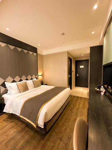 a bedroom with a large bed with a large headboard at SHANGHAI-DECO Hotel-Free shuttle bus to Pudong Airport and Disneyland in Shanghai