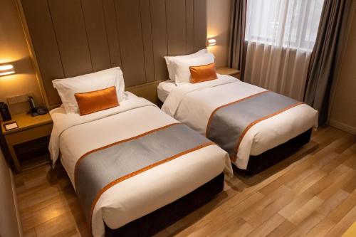 a hotel room with two beds in a room at SHANGHAI-DECO Hotel-Free shuttle bus to Pudong Airport and Disneyland in Shanghai