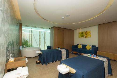 a room with two beds and a bath tub at Amari Hua Hin in Hua Hin