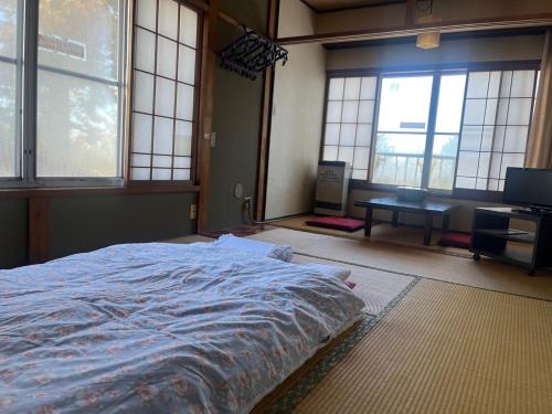 Кровать или кровати в номере 銀明荘