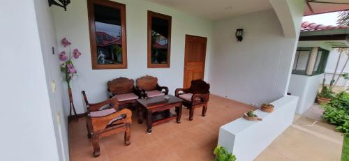 a dining room with chairs and a table in a room at Meyers Hua Hin in Hua Hin