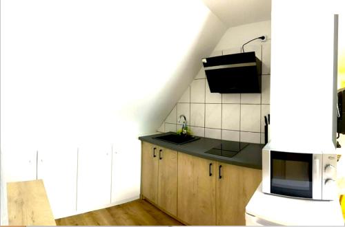 a kitchen with a sink and a microwave at Home Inn Hotel in Dormagen