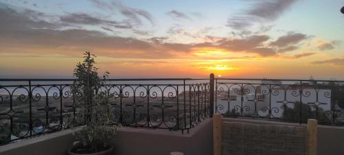 a view of the sunset from a balcony at SurfAppart Morocco in Tamraght Ouzdar