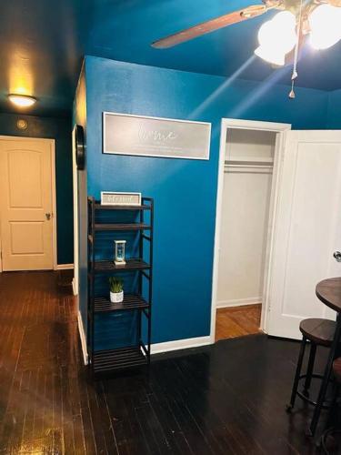 a room with a blue wall with a shelf in it at A place like nowhere else in Lawton