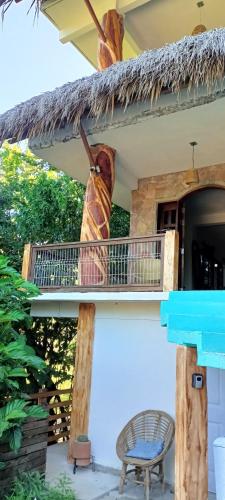 a large butterfly on the balcony of a house at Mar de Fondo in Puerto Escondido