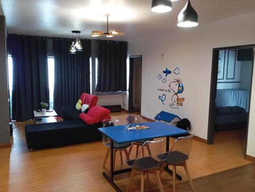 雲頂高原的住宿－10Pax Deluxe Apartment , CloudView Snoopy Theme, Amber Court, Genting Highlands，客厅配有蓝色桌子和沙发