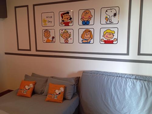 a bedroom with a bed and some pictures on the wall at 10Pax Deluxe Apartment , CloudView Snoopy Theme, Amber Court, Genting Highlands in Genting Highlands
